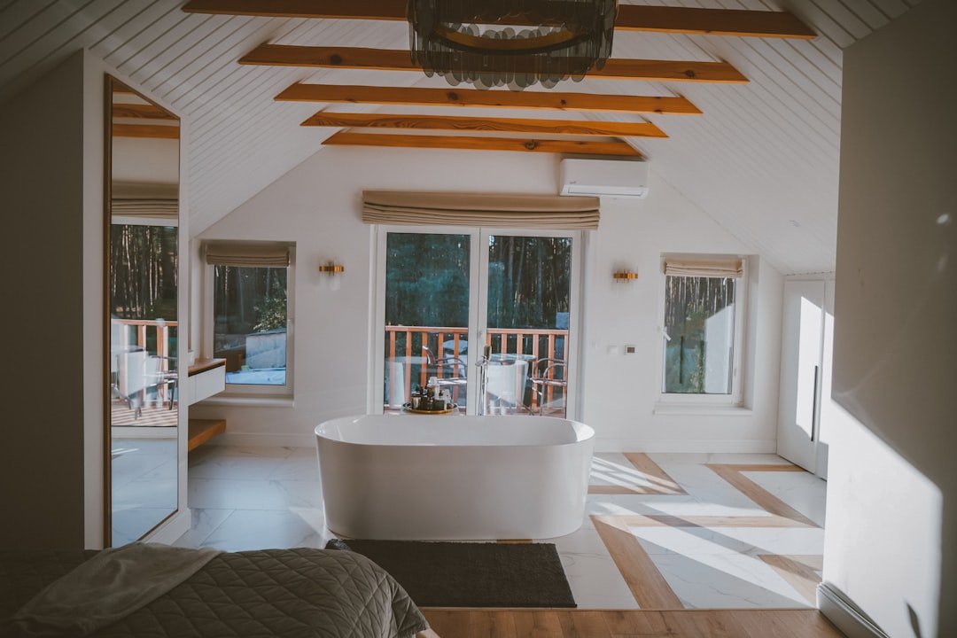 a large bathroom with a tub and a large window