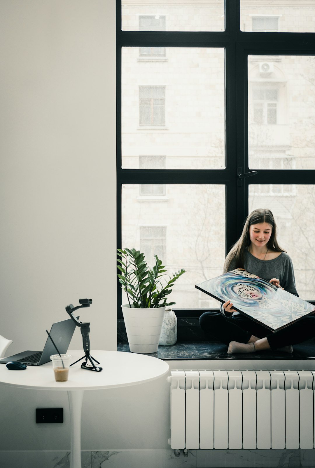 a woman sitting on a couch reading a book
