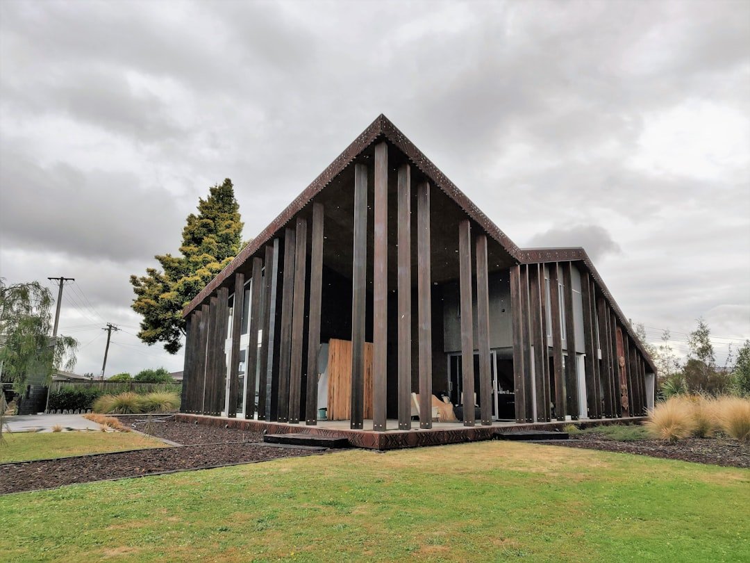a large wooden building sitting on top of a lush green field