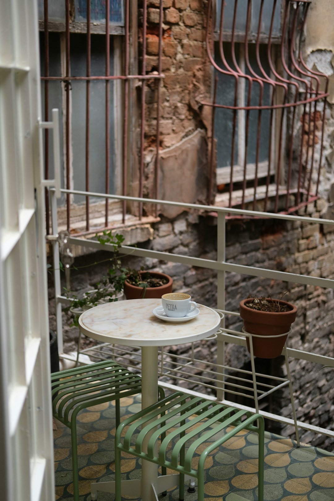 A small table and chairs on a balcony