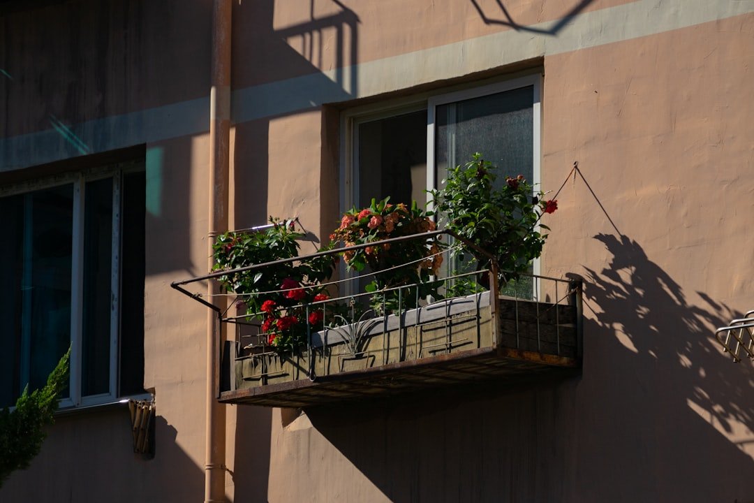 a balcony with a planter filled with flowers