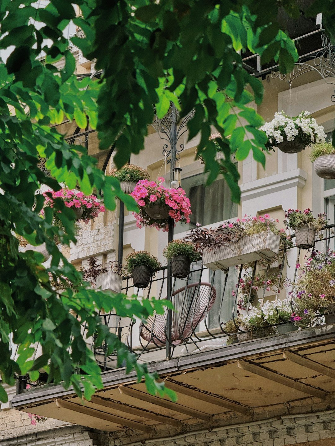 The balcony of a building with flowers on the balconies