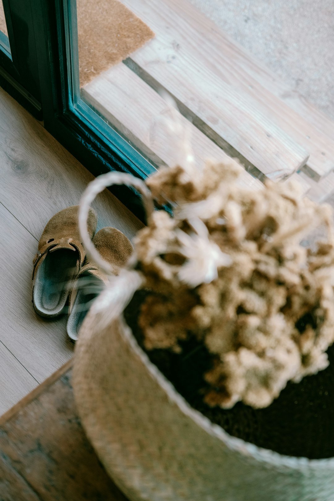 A basket and slippers sit near a door.