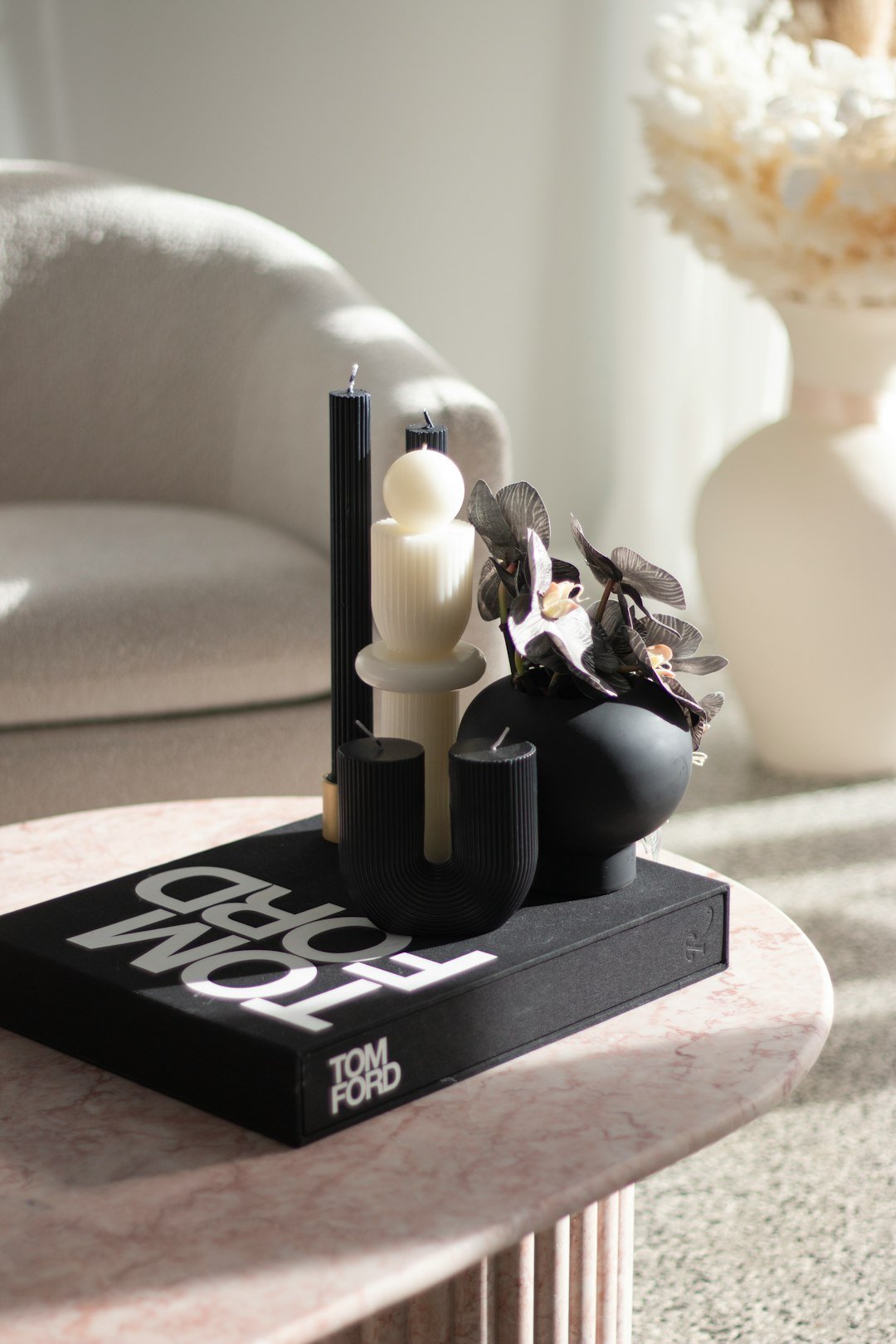 a black and white object with a candle on a black surface