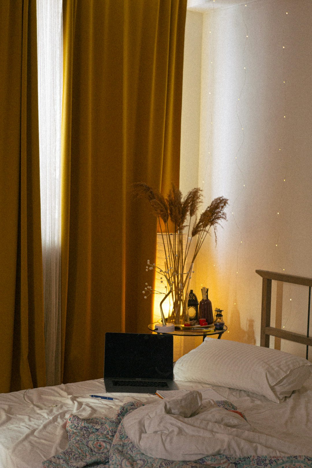 a laptop computer sitting on top of a bed