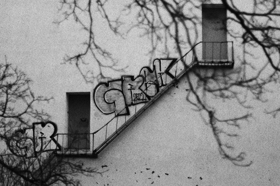 a black and white photo of graffiti on the side of a building