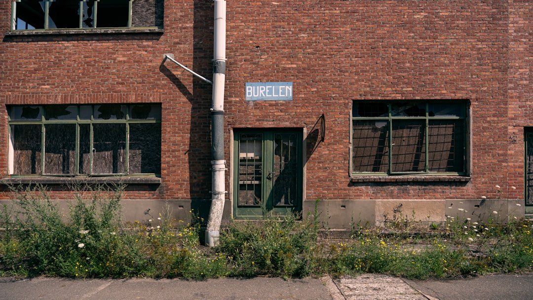 a brick building with a street sign in front of it