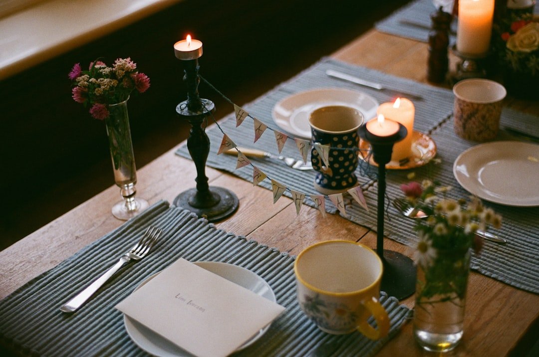 a table set for a meal with candles and plates