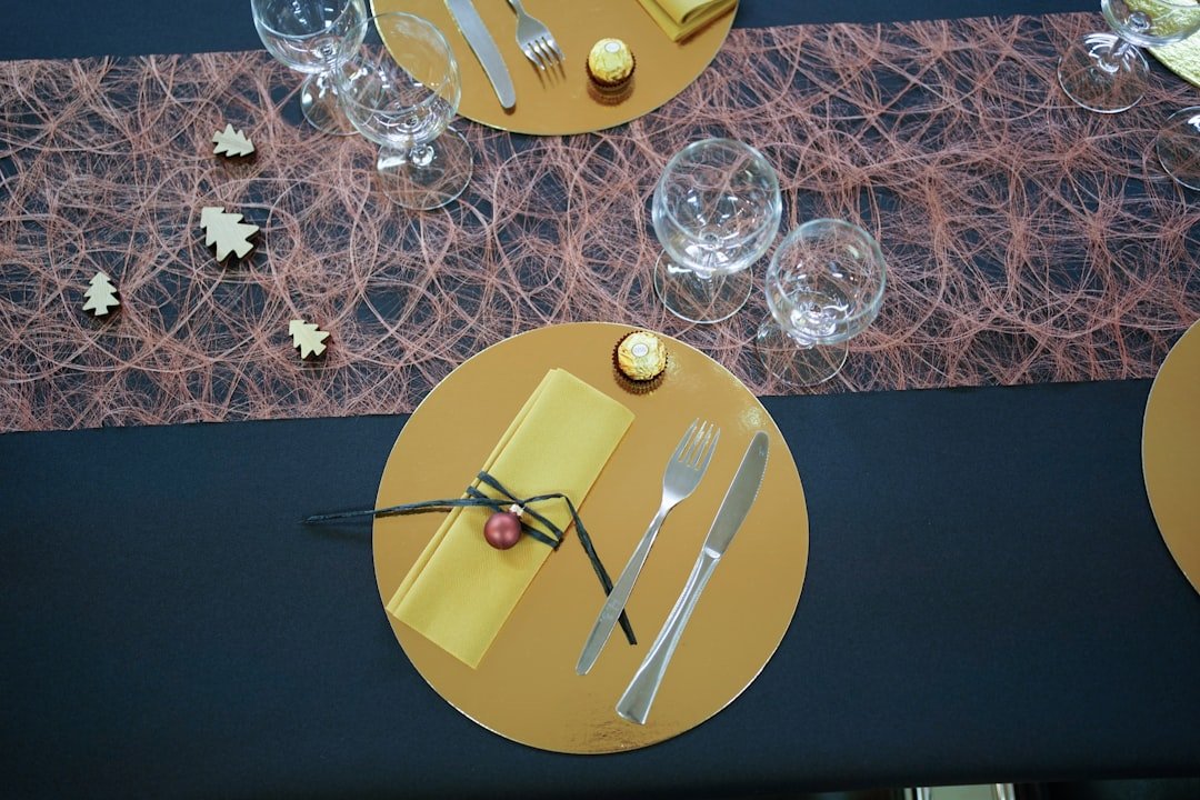 chocolate near fork, knife, and table napkin beside long-stem wine glasses