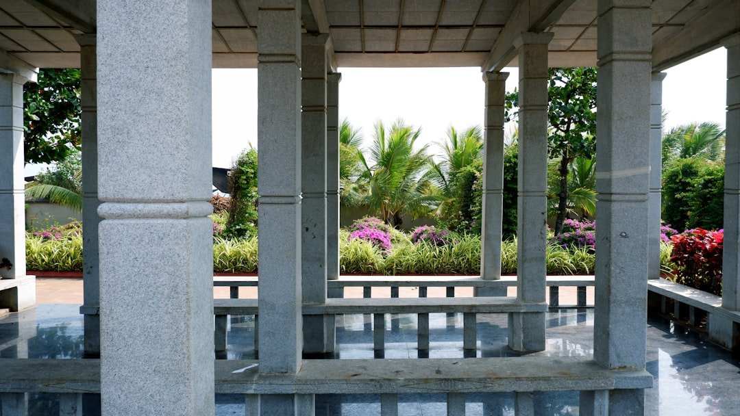 Stone columns frame a tranquil garden view.