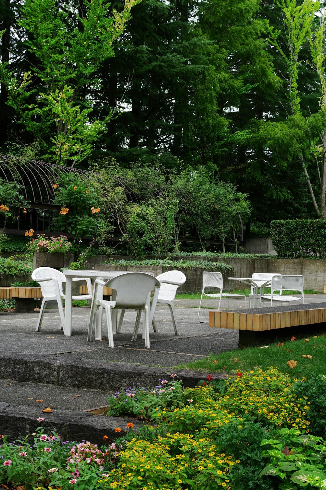 A group of white chairs sitting on top of a wooden deck