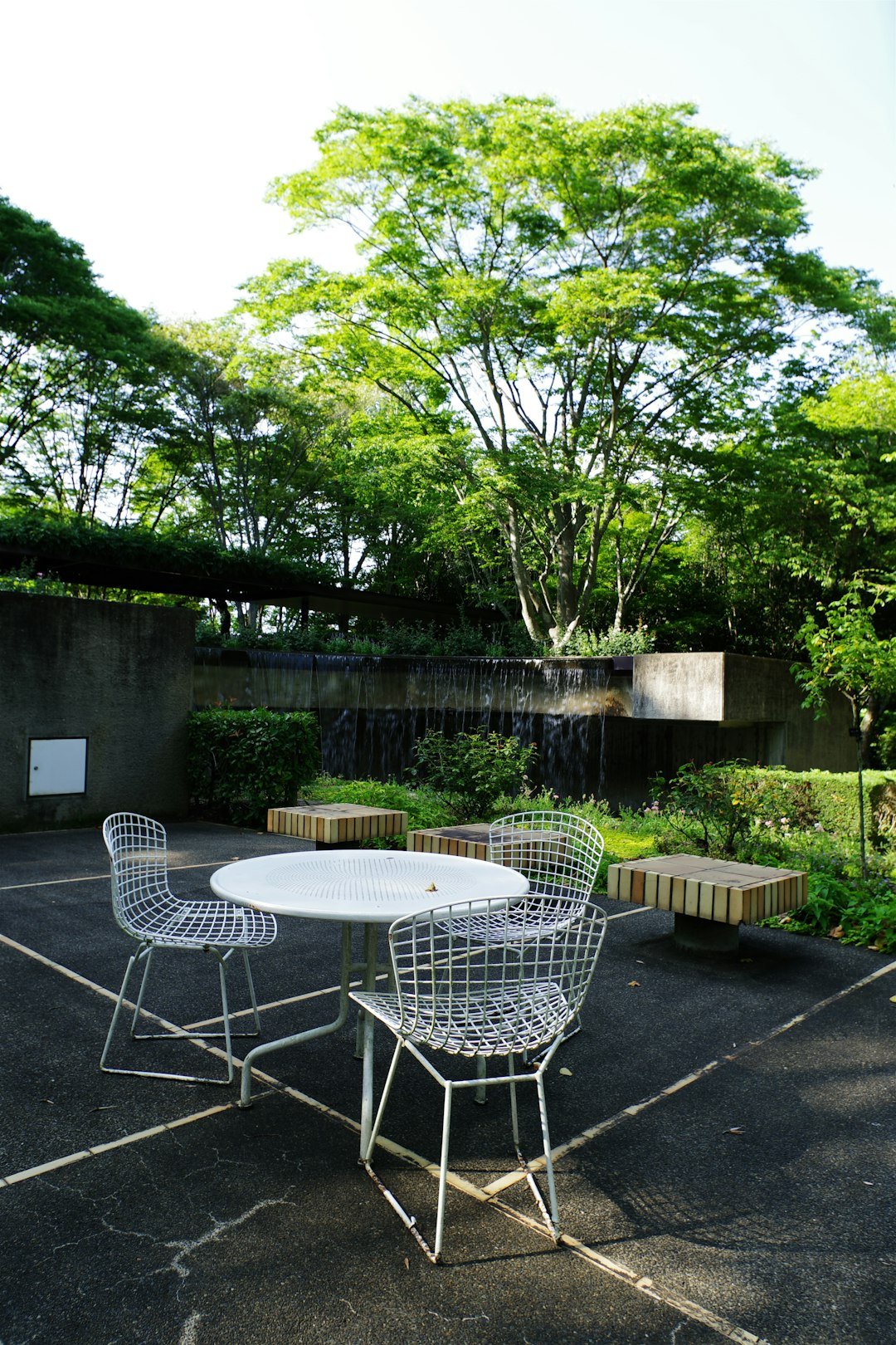 A white table and chairs sitting on top of a parking lot