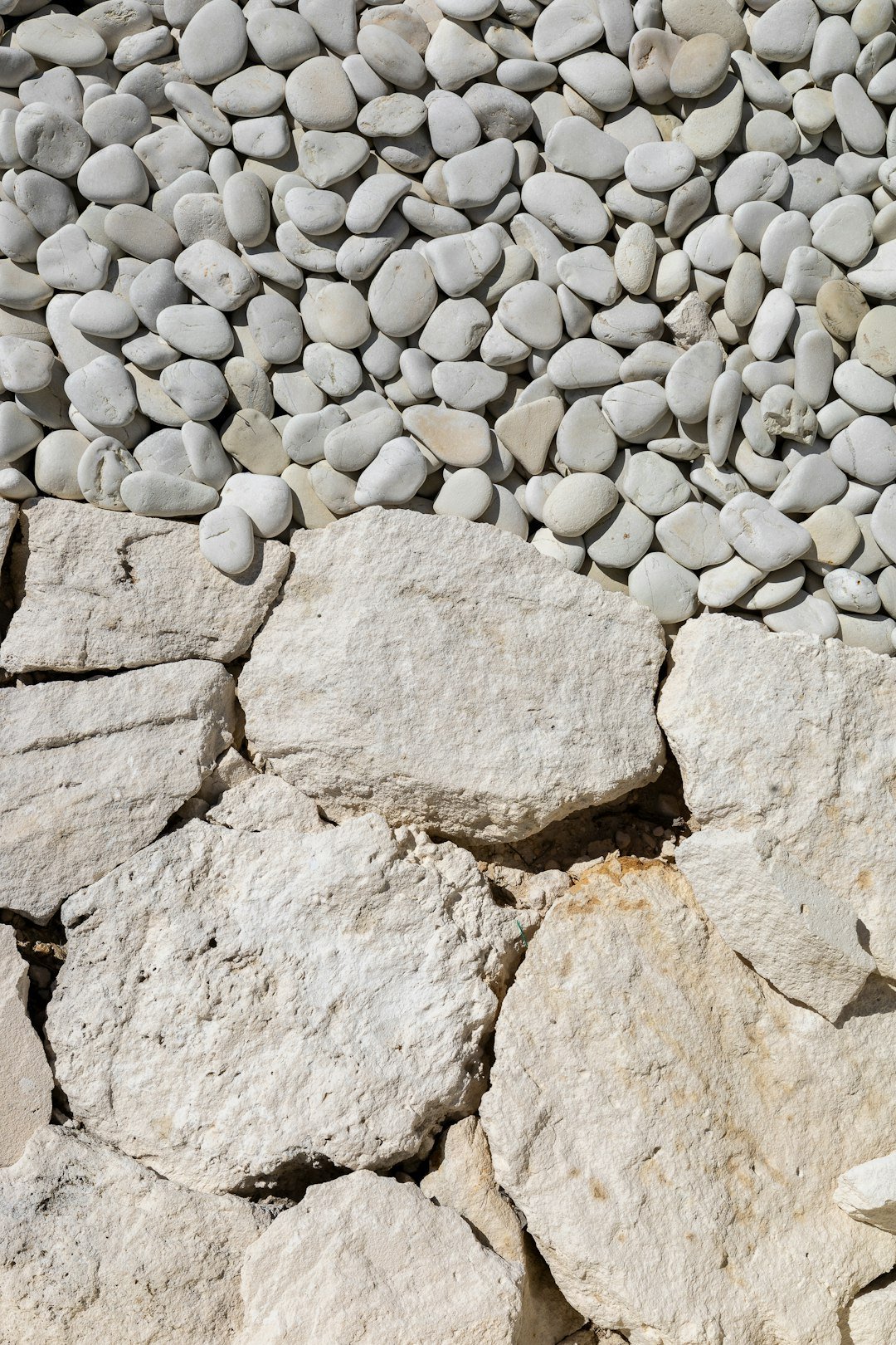 White pebbles and rocks form a textured surface.