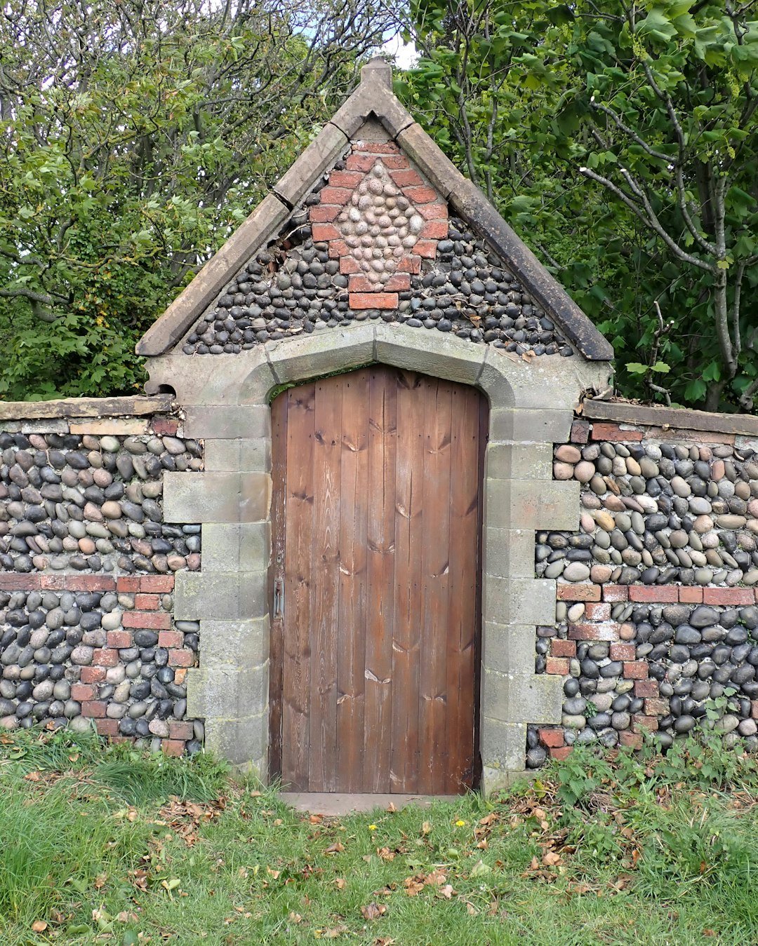 a small brick building with a door