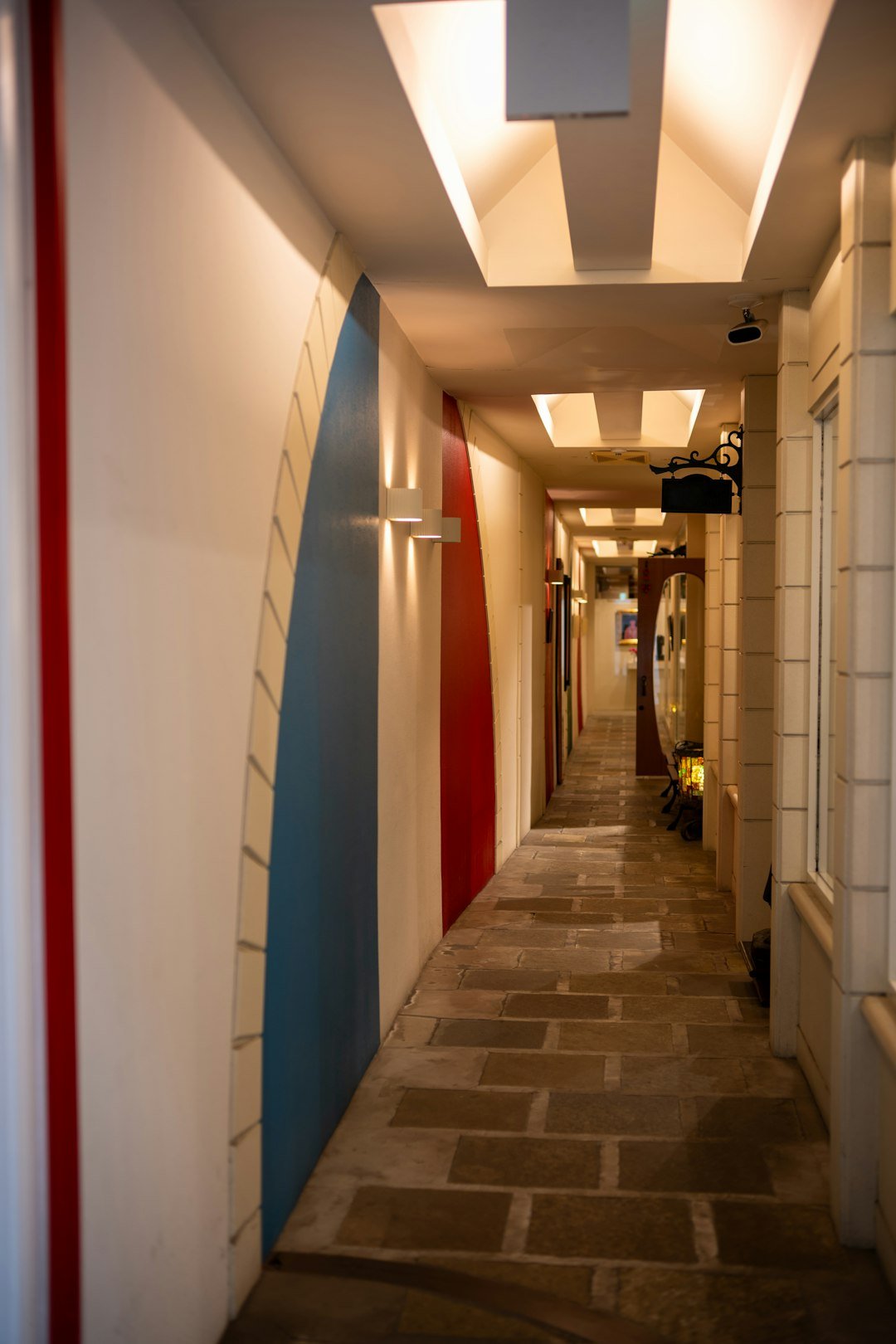 A narrow hallway adorned with colorful stripes.