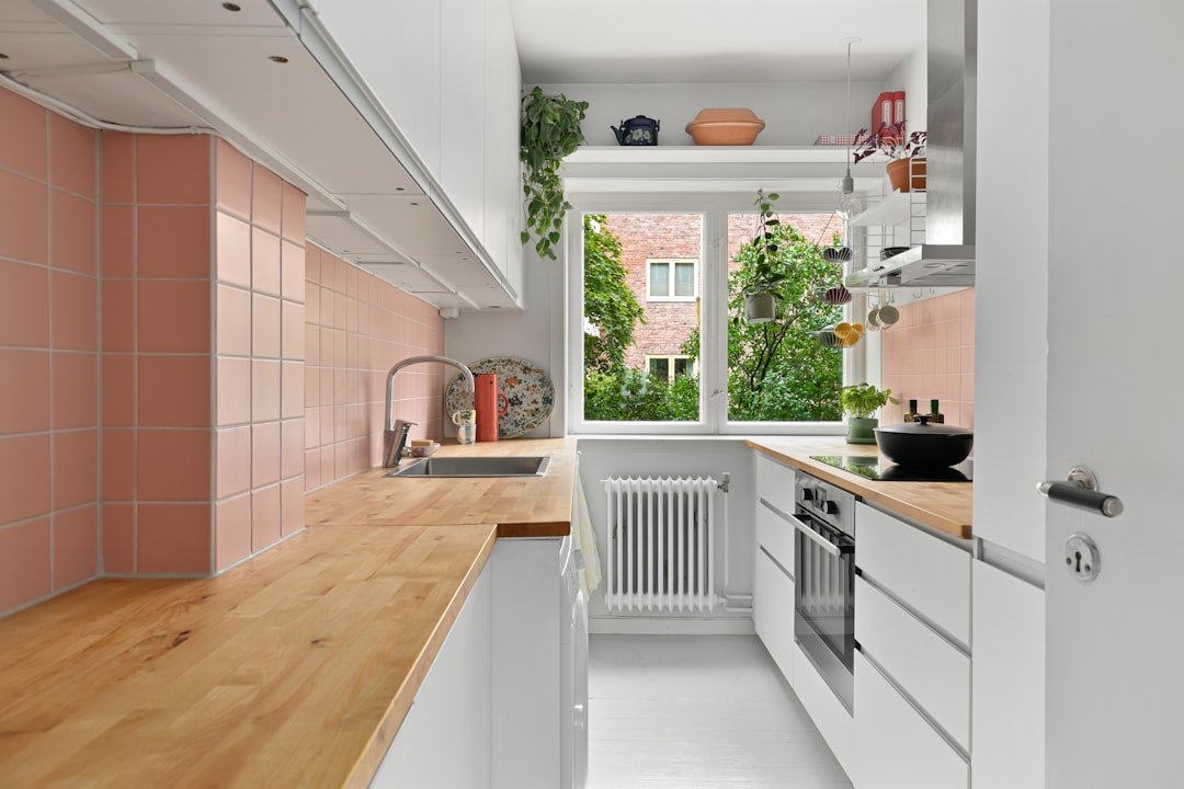 A kitchen with a wooden counter top next to a window
