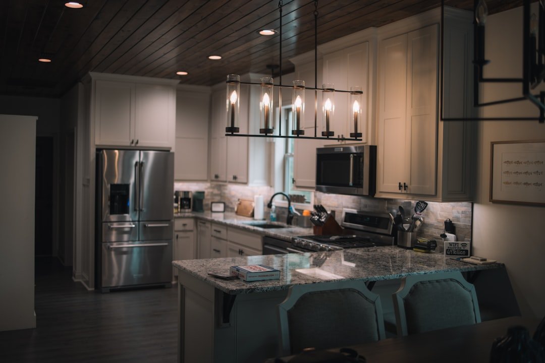 A large kitchen with a center island and a refrigerator