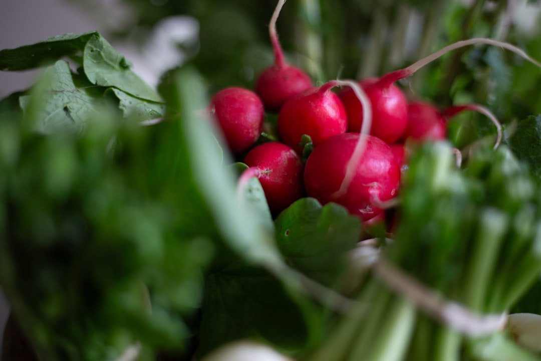 a bunch of radishes sitting on top of green leaves