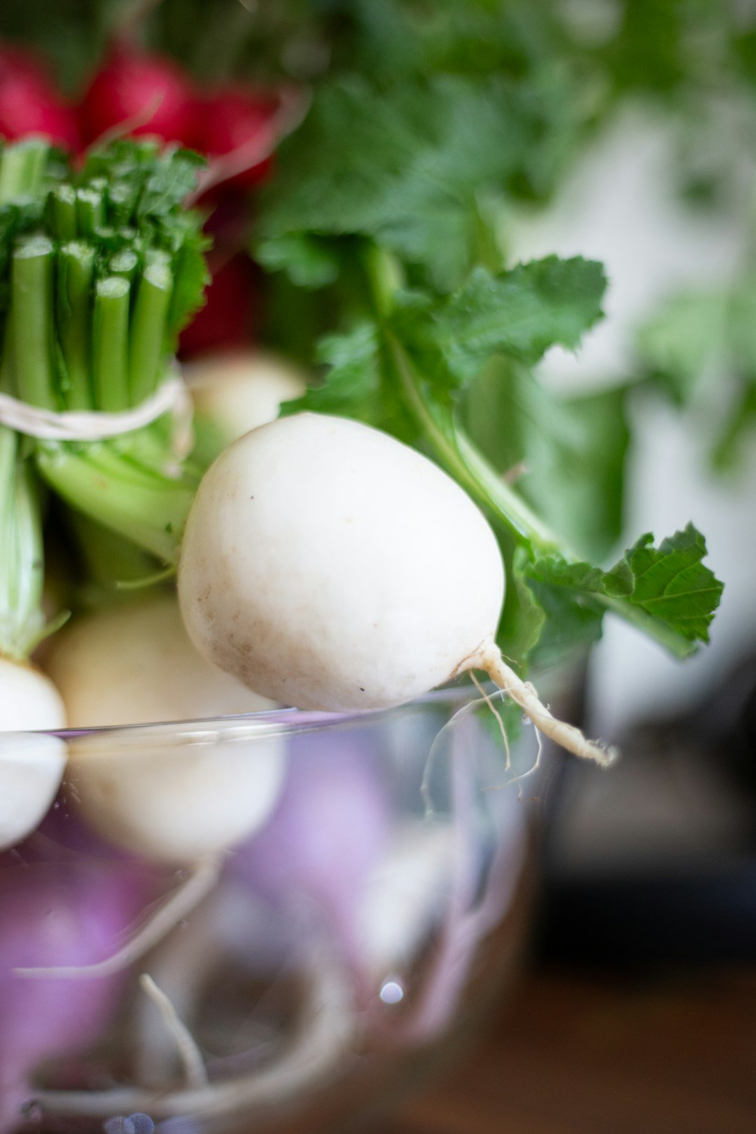 a glass bowl filled with different types of vegetables