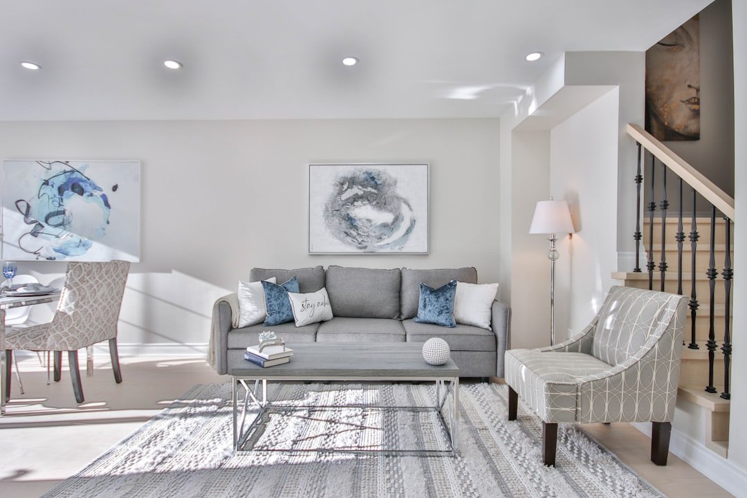 a living room filled with furniture and a staircase