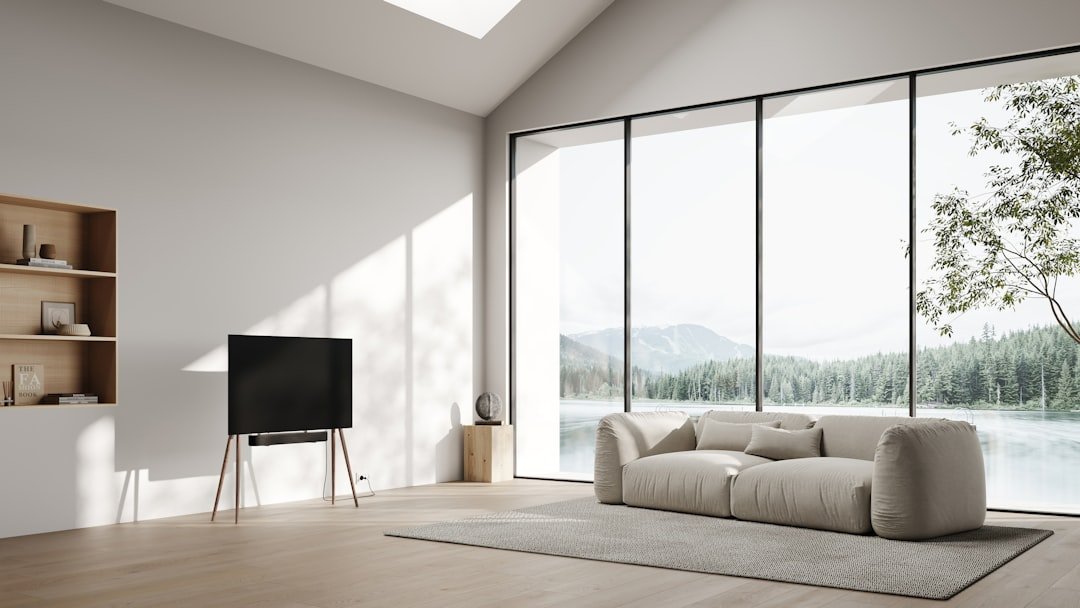 a living room with a large window and a white couch