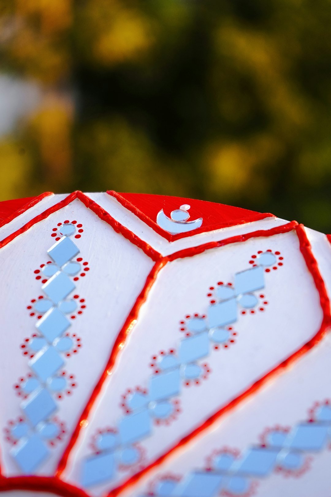 A close up of a red and white umbrella