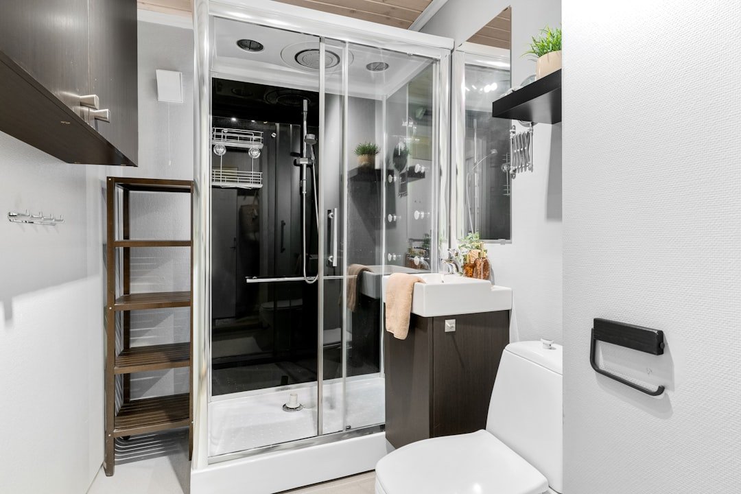 A white toilet sitting next to a walk in shower