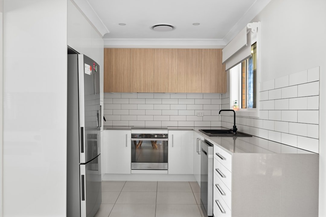 A kitchen with a refrigerator and a sink