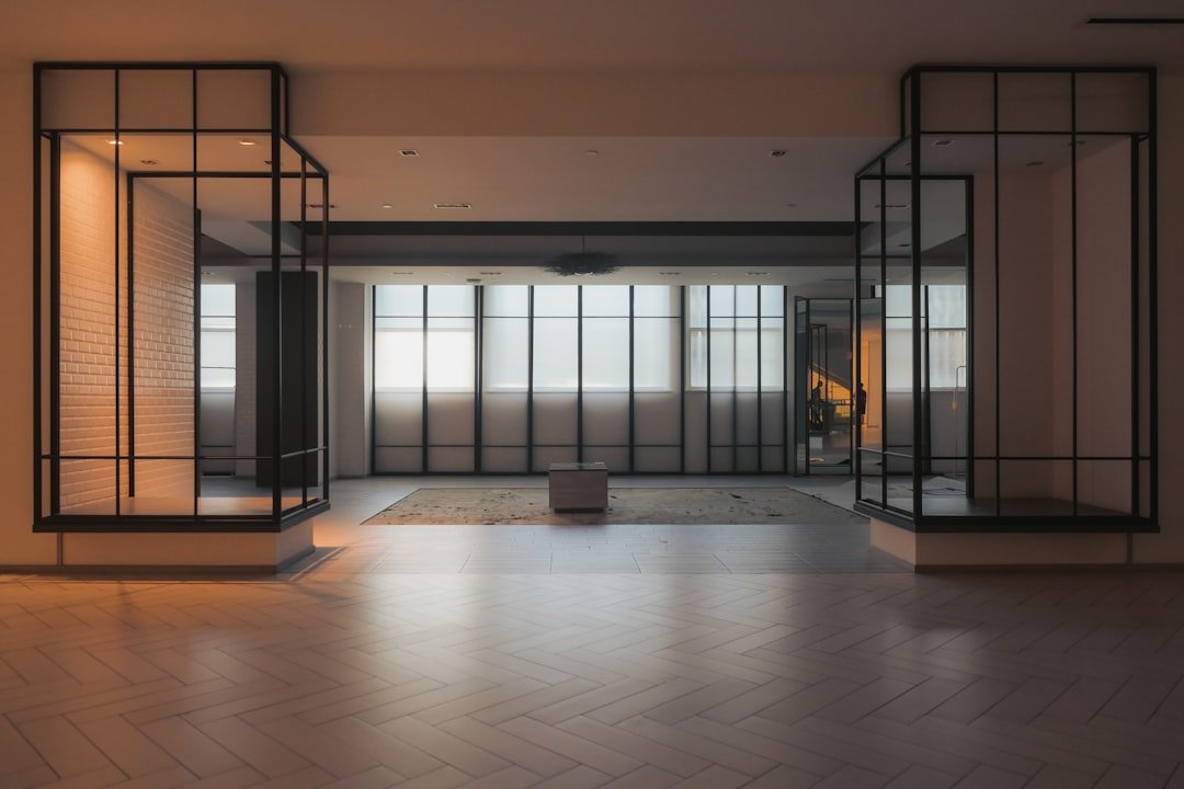 A modern interior features windows and geometric accents.