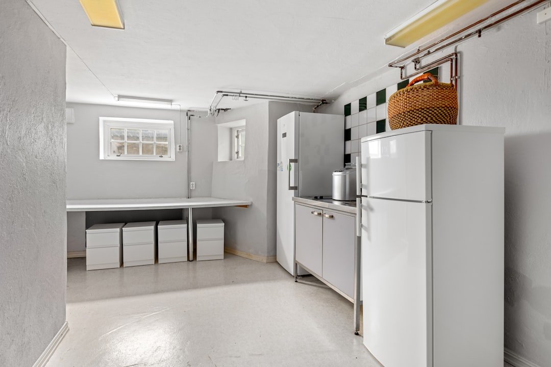 A white refrigerator freezer sitting inside of a kitchen