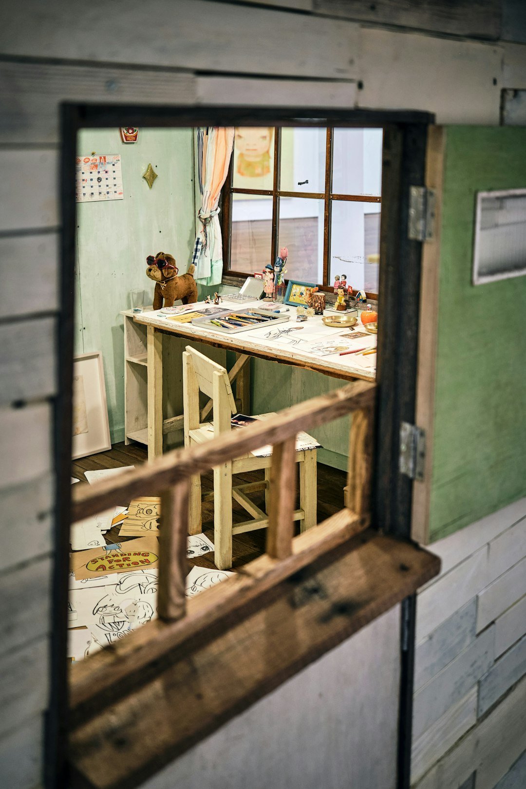 View of a creative desk through an open window.