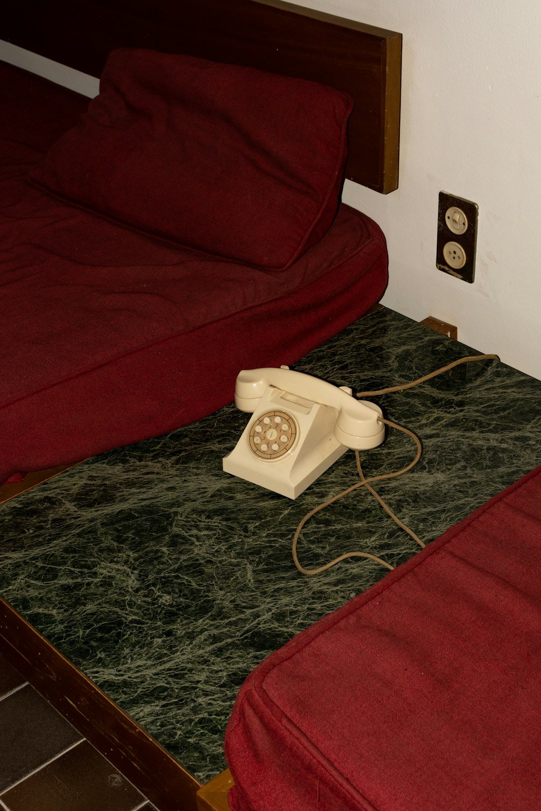 A bed with a phone on top of it