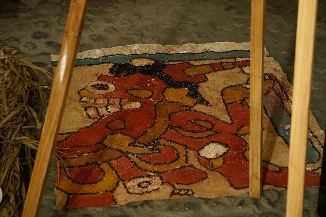 a painting on the ground next to two wooden poles