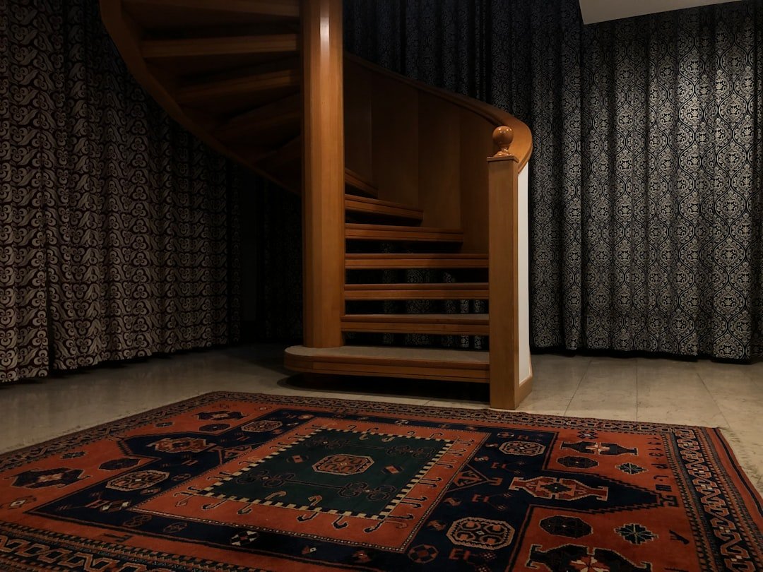 a spiral staircase in a house with a rug on the floor