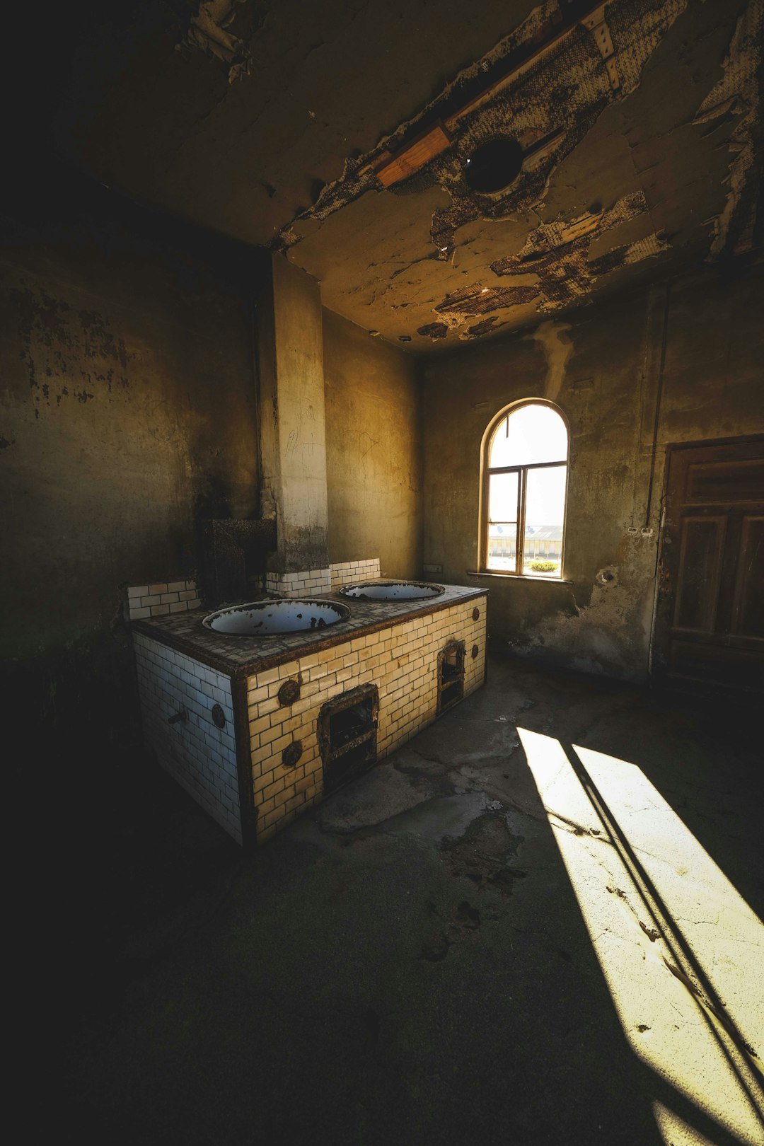 An old room with a stove and a window