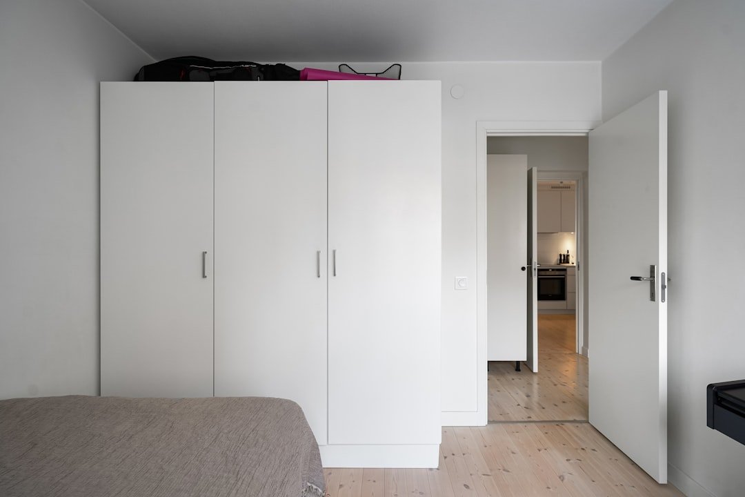 A bedroom with a bed and a closet