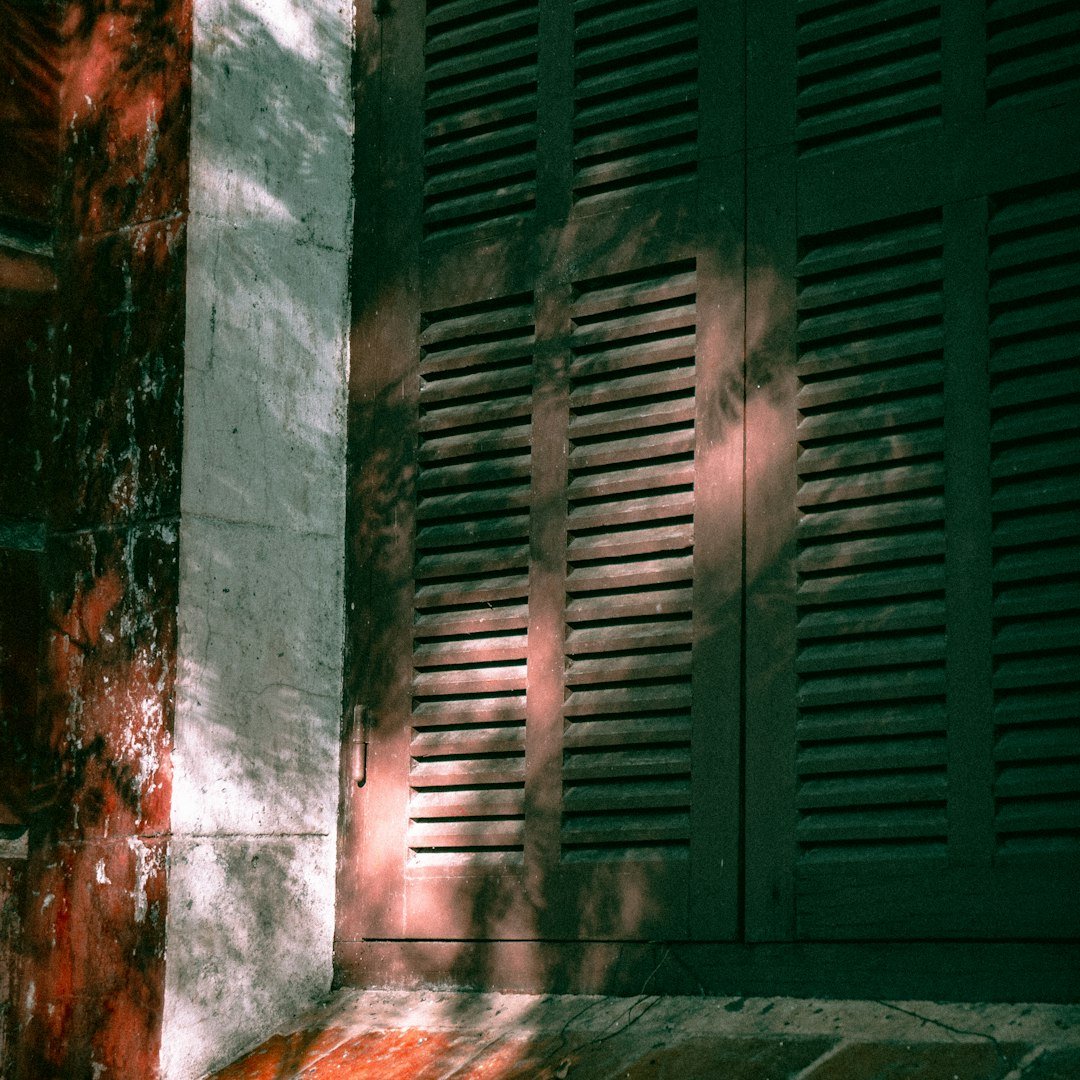 A red fire hydrant sitting on the side of a building
