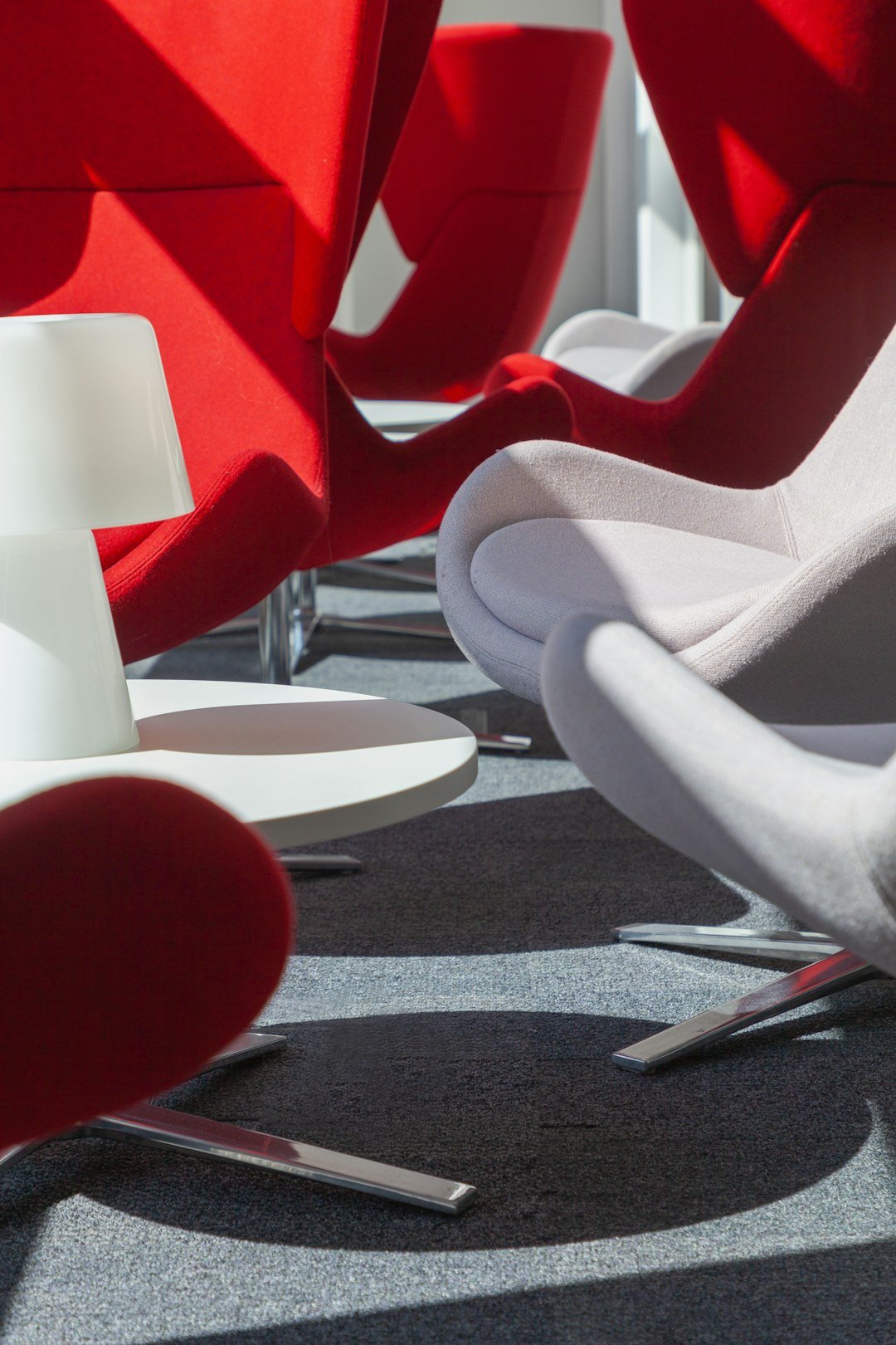 a group of red and white chairs sitting next to each other