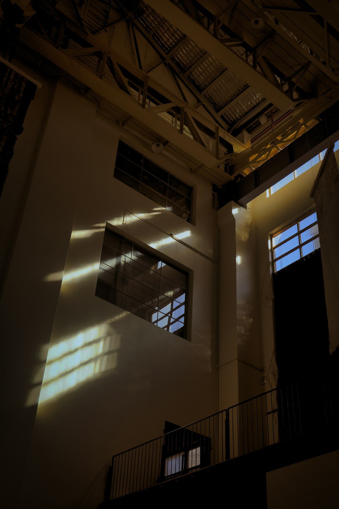 a large room with two windows and a balcony
