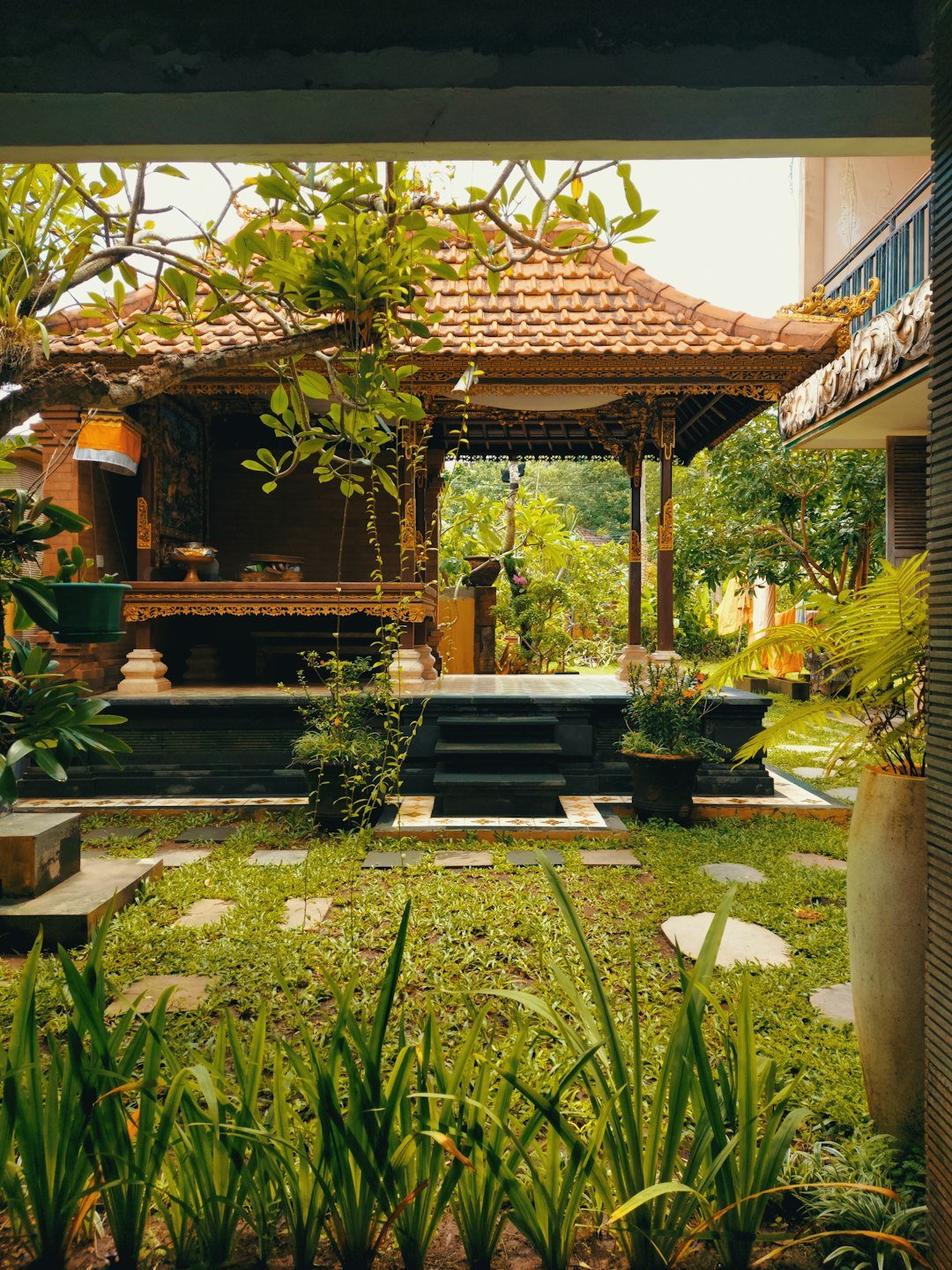 A small garden with a gazebo and steps leading to it