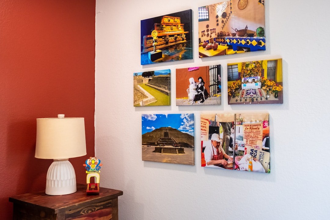 a wall with a lamp and pictures on it