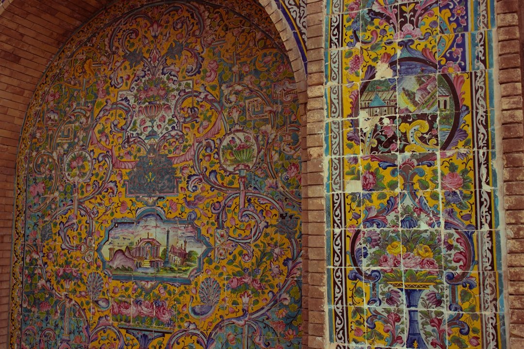 A colorfully painted wall with a doorway in the middle of it