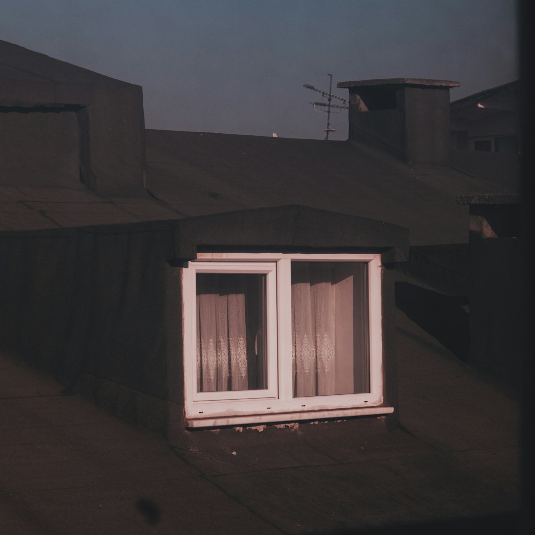 a white window sitting on the side of a building