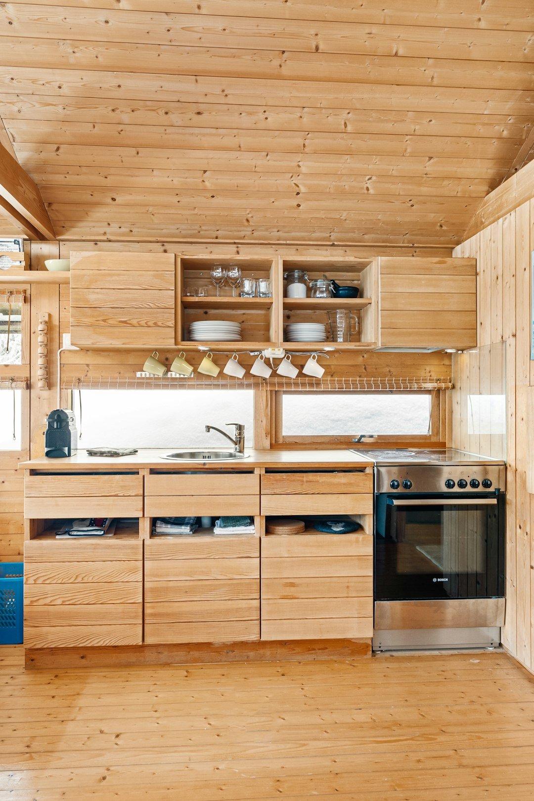 A kitchen with wooden cabinets and a stove top oven