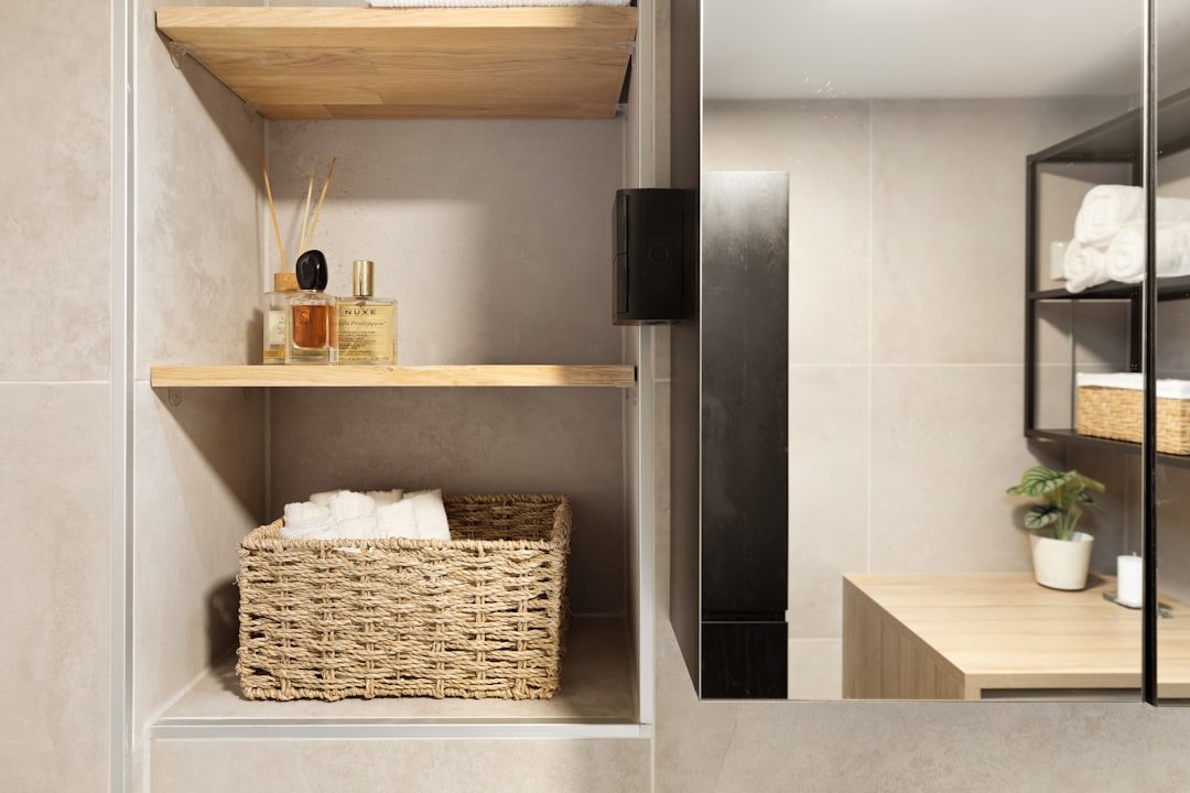 A bathroom with a sink, mirror and shelves