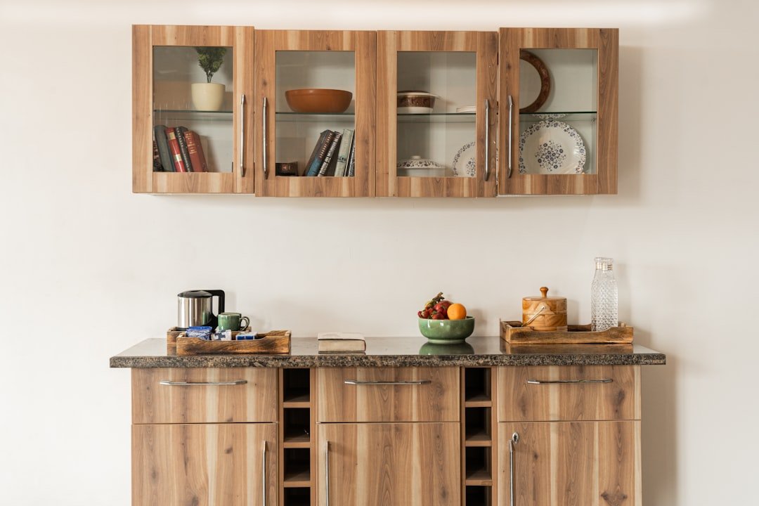 a kitchen with wooden cabinets and a bowl of fruit