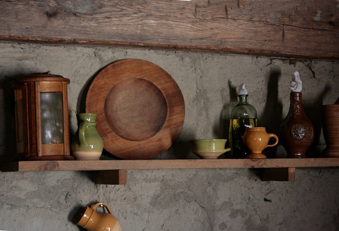 A shelf filled with different types of pottery