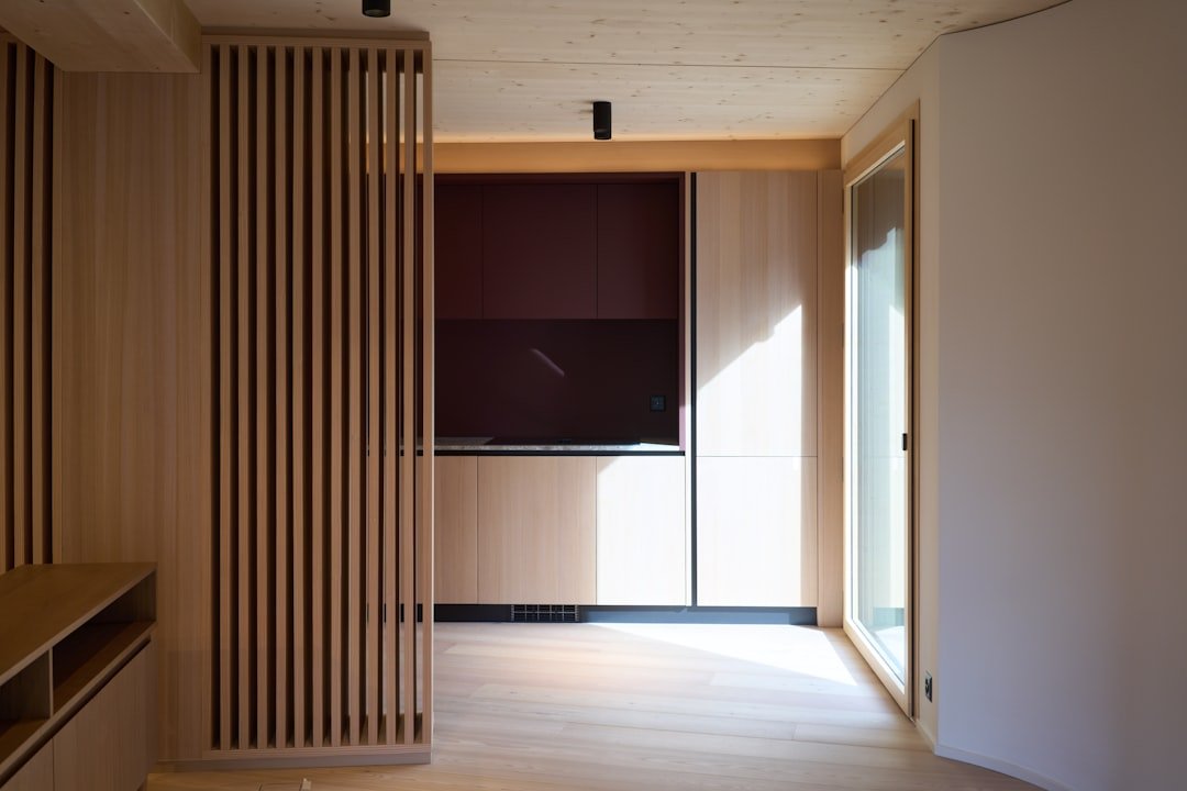 A room with a TV and a large window